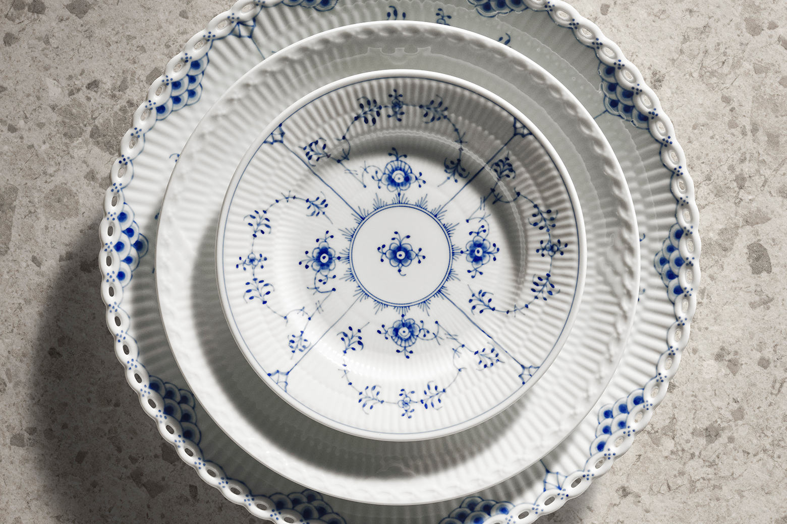 A beautiful stack of plates with the Blue Fluted Plain plate at the top